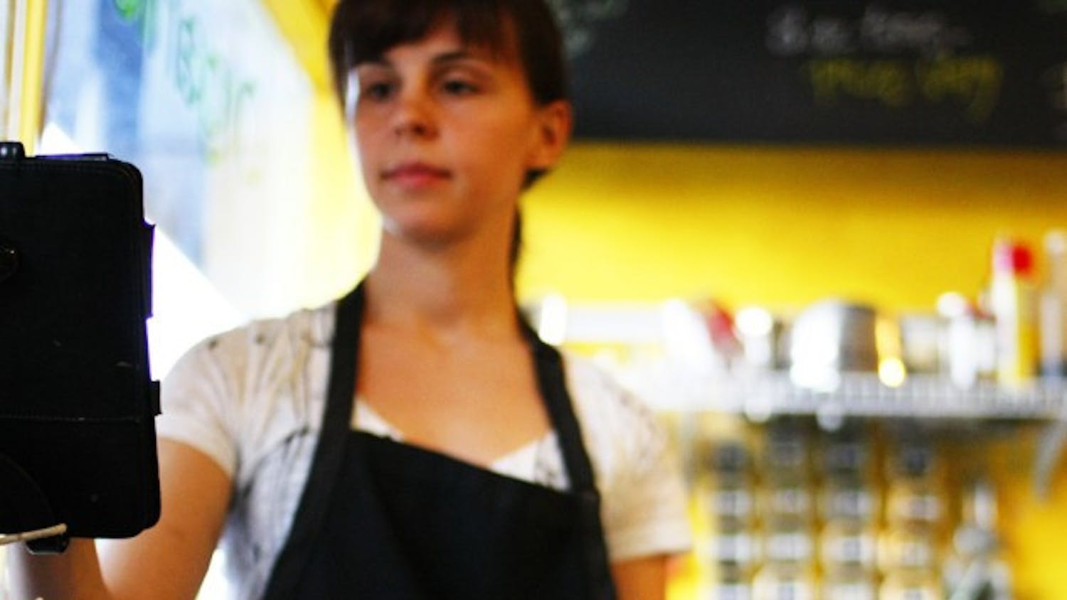 Emily Schwartz, 25, serves coffee at Karma Cream on West University Avenue. A new study published in the New England Journal of Medicine linked drinking coffee to living longer.