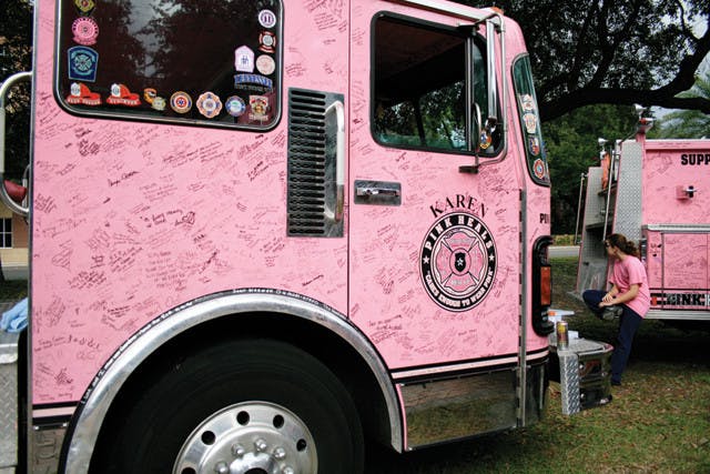 Pink firetrucks sit on the Ben Hill Griffin Stadium north lawn as part of the Pink Heals Tour Wednesday afternoon. The trucks made their way to Gainesville from Glendale, Ariz., to raise awareness for breast cancer.