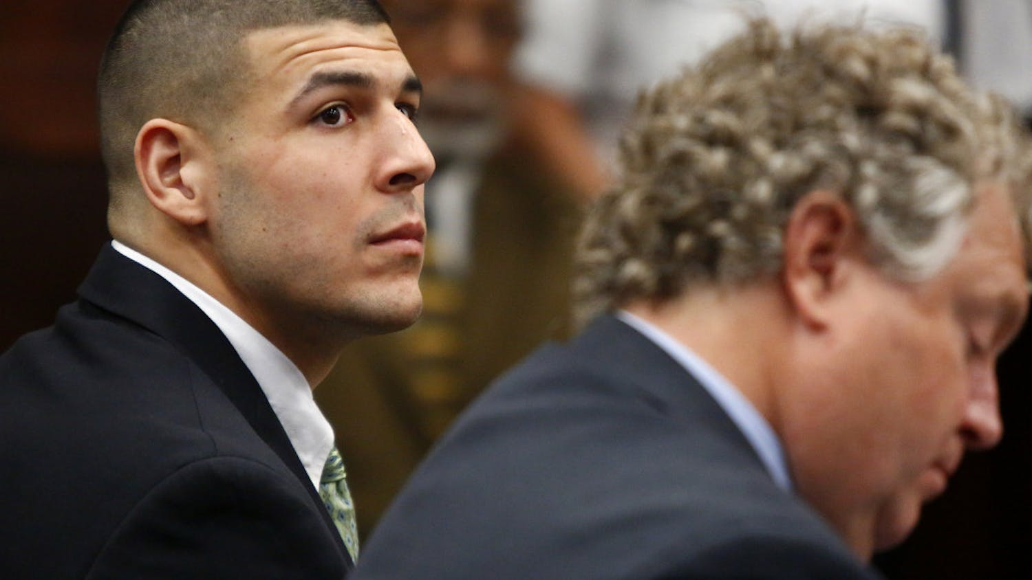 Former New England Patriots tight end Aaron Hernandez listens to the prosecution's summary of facts as he is arraigned on homicide charges at Suffolk Superior Court in Boston, Wednesday. Hernandez pleaded not guilty in the shooting deaths of Daniel de Abreu and Safiro Furtado. He already faces charges in the 2013 killing of semi-pro football player Odin Lloyd.