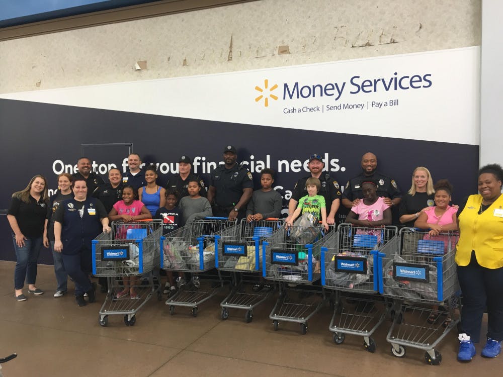 <p><span id="docs-internal-guid-75e0071e-7fff-5f1e-4676-7b01f65e16b2"><span>All of the GPD School Resource Officers with the children and their purchased items.</span></span></p>