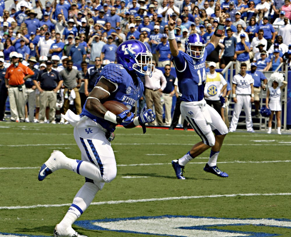 Kentucky running back Jojo Kemp (3) scores against Tennessee-Martin on a run as quarterback Patrick Towles (14) celebrates during Kentucky's 59-14 win against UT-Martin on Aug. 30 in Lexington, Kentucky.