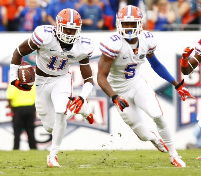 Linebacker Neiron Ball (11) returns an interception thrown by Georgia’s Aaron Murray during the first quarter of UF’s 17-9 loss on Saturday at EverBank Field.