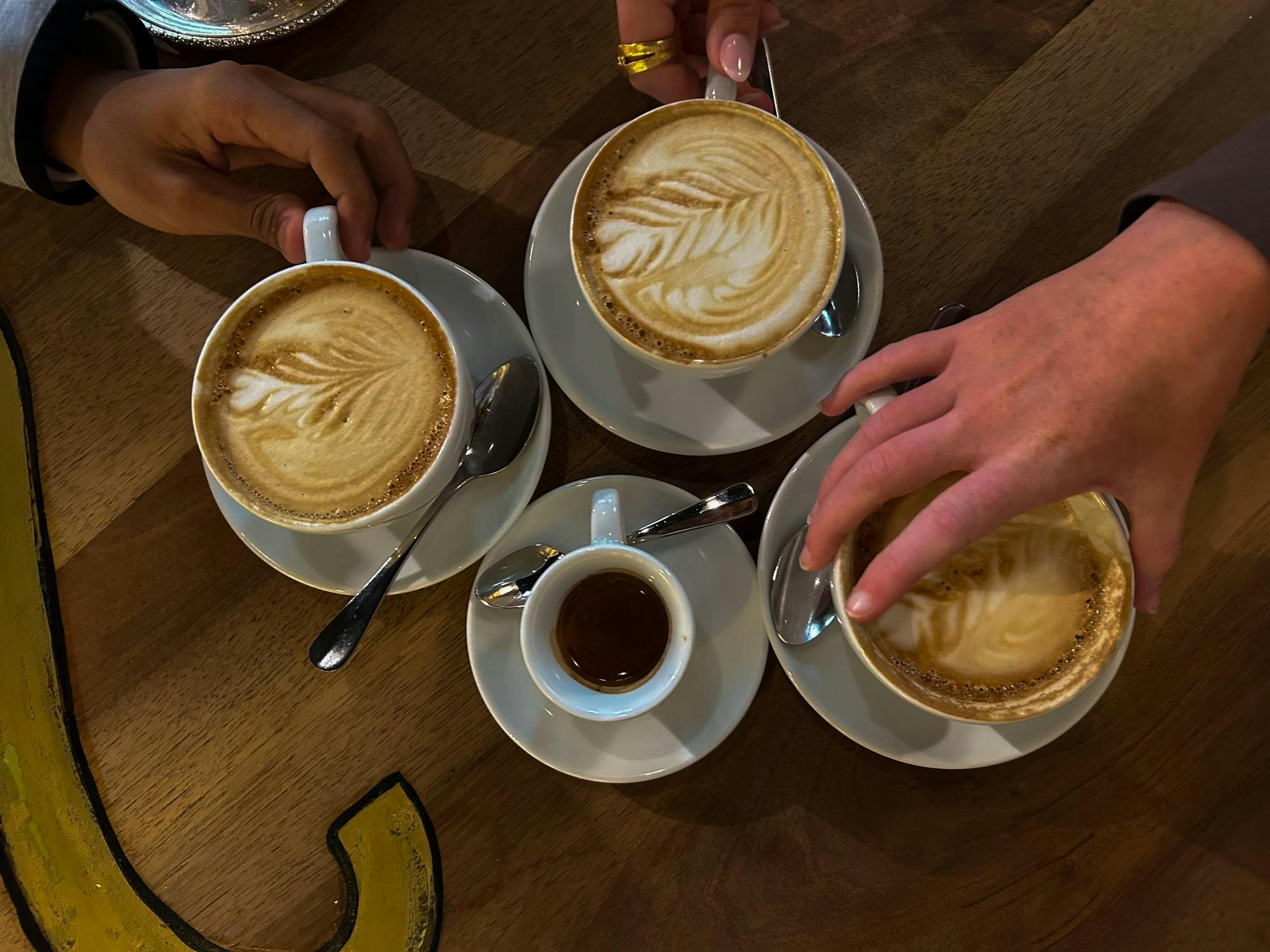 An espresso shot and three cappucinos sit on a table in Babu’s Bakery & Coffeehouse, Wednesday, May 6, 2026, in Zurich, Switzerland.