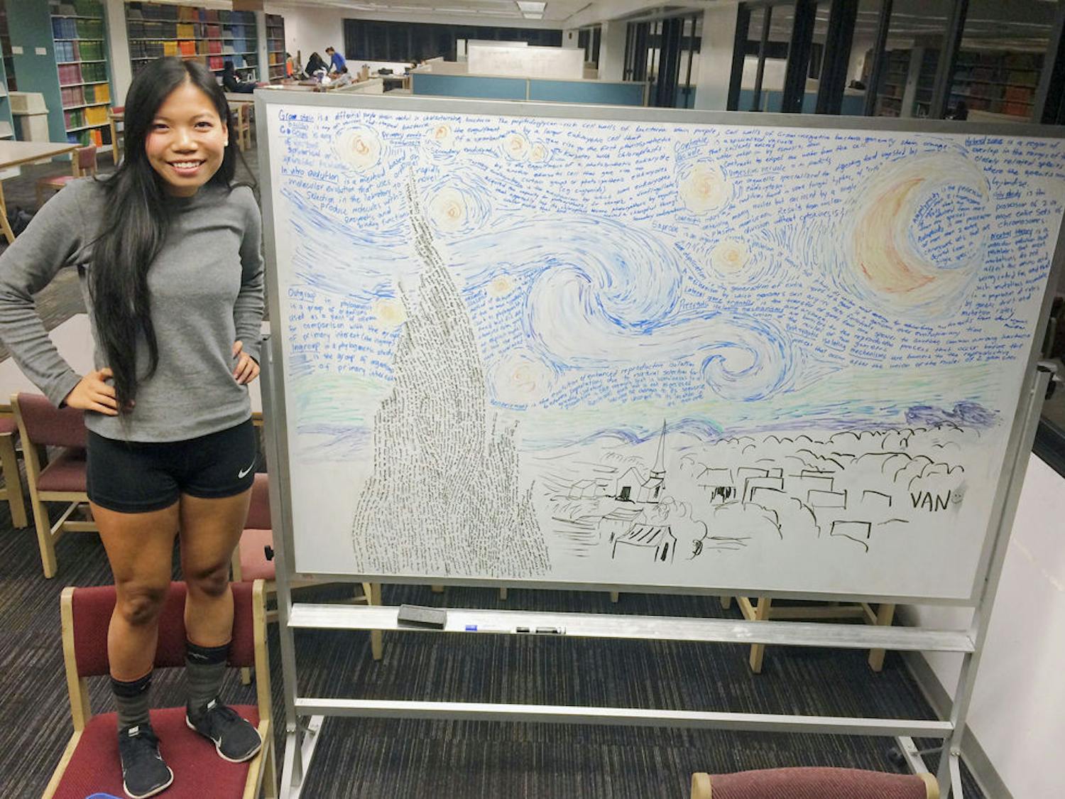 Van Truong, a 19-year-old anthropology sophomore, poses next to the “Starry Night” art piece she made on a whiteboard with her biology notes. Truong is applying for a grant within the Bob Graham Center for Public Service to bring the arts and sciences together.