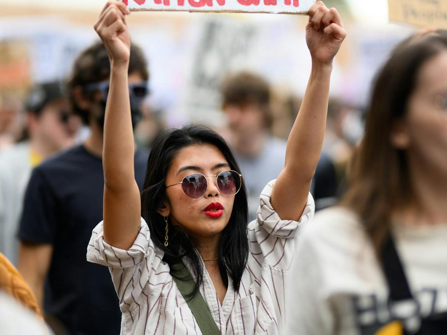 A demonstrator holds a sign during an ICE protest organized by YDSA, Friday, Jan. 30, 2026, along University Avenue in Gainesville, Fla.