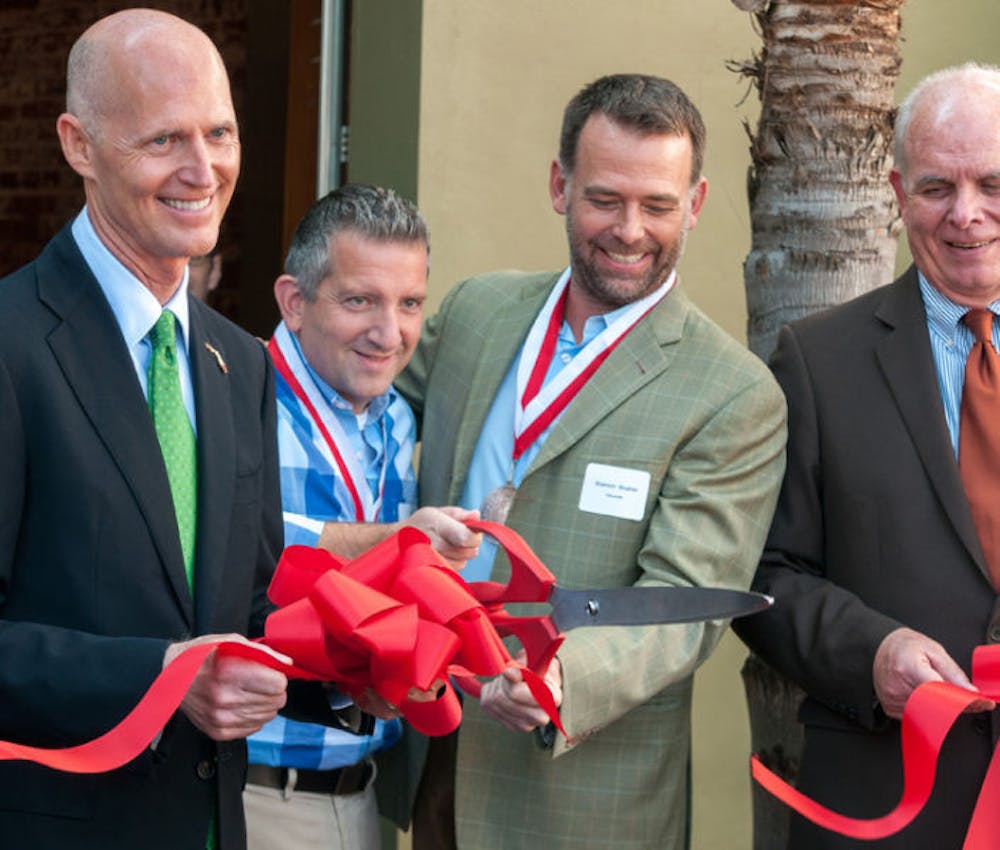 <p>Gov. Rick Scott, Darryl Cilli, Shannon Slusher and UF President Bernie Machen cut a ribbon after the ceremony at 160over90 on Wednesday morning promoting the new headquarters in downtown Gainesville. 160over90 is an international branding agency and is creating 35 new jobs with a $500,000 capital investment.</p>