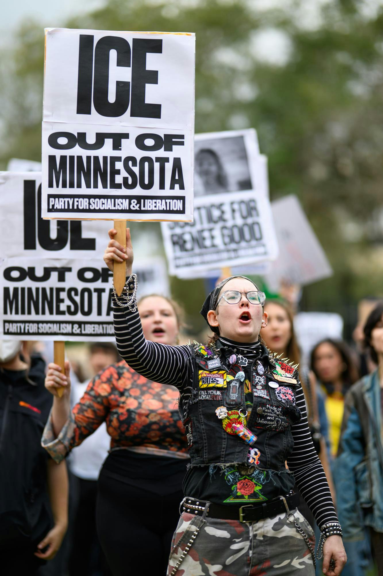 A demonstrator holds a sign and chants during an ICE protest organized by YDSA, Friday, Jan. 30, 2026, on Bo Diddley Plaza in Gainesville, Fla.