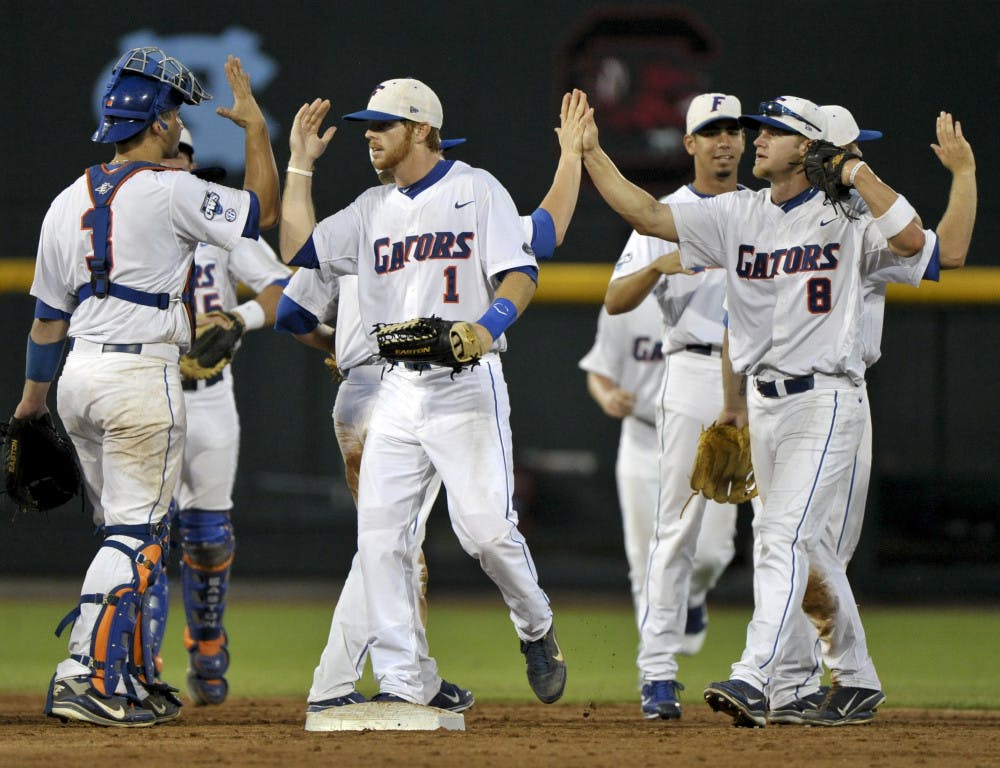 Bryson Smith, (1) pictured center, reached base in all five plate appearances in Florida's 8-4 win over Texas Saturday at the NCAA College World Series in Omaha, Neb. Smith met with reporters afterwards for the first time since his embarrassing arrest in mid-March.