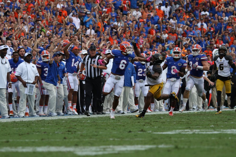 <p>Quincy Wilson (6) stiff-arms a Missouri defender after intercepting a pass during Florida's 40-14 homecoming win over Missouri on Oct. 15, 2016, at Ben Hill Griffin Stadium.</p>