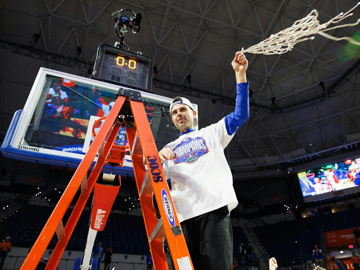 Florida head coach Todd Golden swings the net in the air after clinching the SEC regular season title following a win in an NCAA college basketball game against Arkansas, Saturday, Feb. 28, 2026, in Gainesville, Fla.