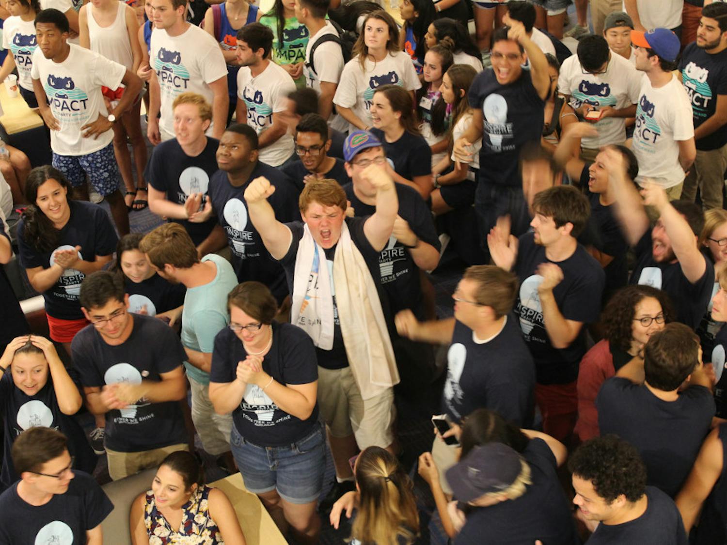 Inspire Party members cheer as Student Government election results are announced Wednesday night. Inspire won 20 seats, while Impact took 29.