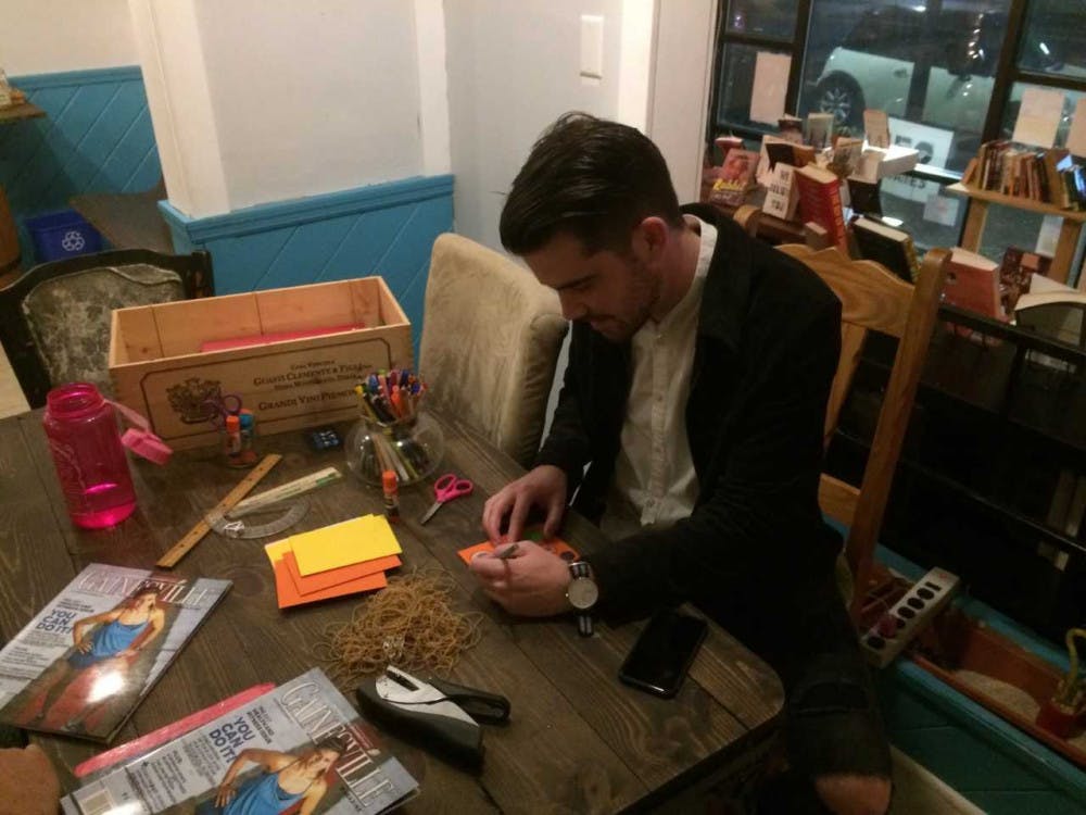 <p dir="ltr"><span>Chris McLeod, 30, works on a zine, or small magazine, at Third House Coffee and Books during the “Create in Place” event.</span></p><p><span> </span></p>