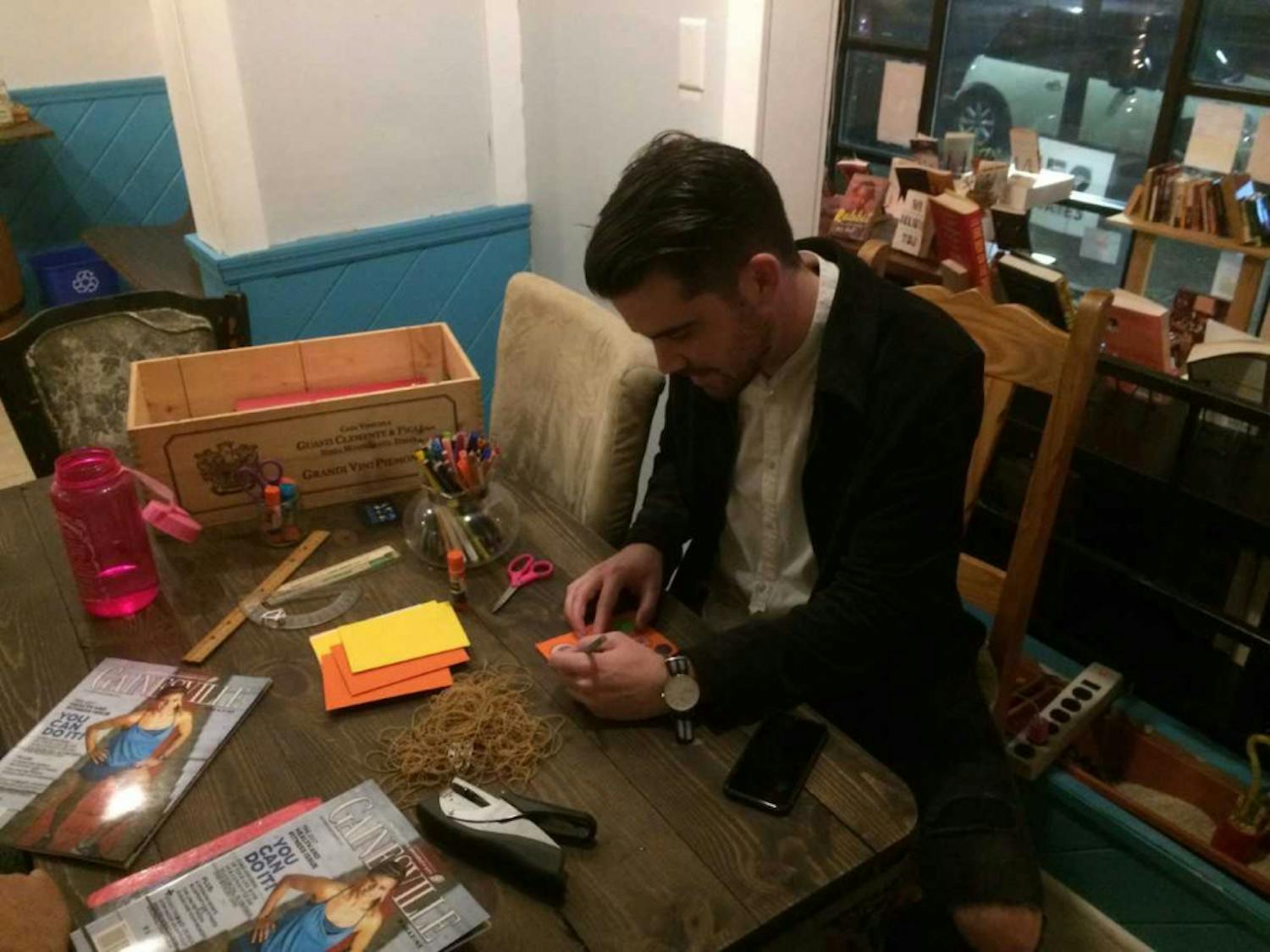 Chris McLeod, 30, works on a zine, or small magazine, at Third House Coffee and Books during the “Create in Place” event. 