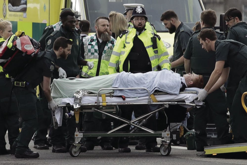 Emergency services staff provide medical attention to injured people on the south side of Westminster Bridge, close to the Houses of Parliament in London, Wednesday, March 22, 2017. London police say they are treating a gun and knife incident at Britain's Parliament "as a terrorist incident until we know otherwise." The Metropolitan Police says in a statement that the incident is ongoing. Officials say a man with a knife attacked a police officer at Parliament and was shot by officers. Nearby, witnesses say a vehicle struck several people on the Westminster Bridge.&nbsp;