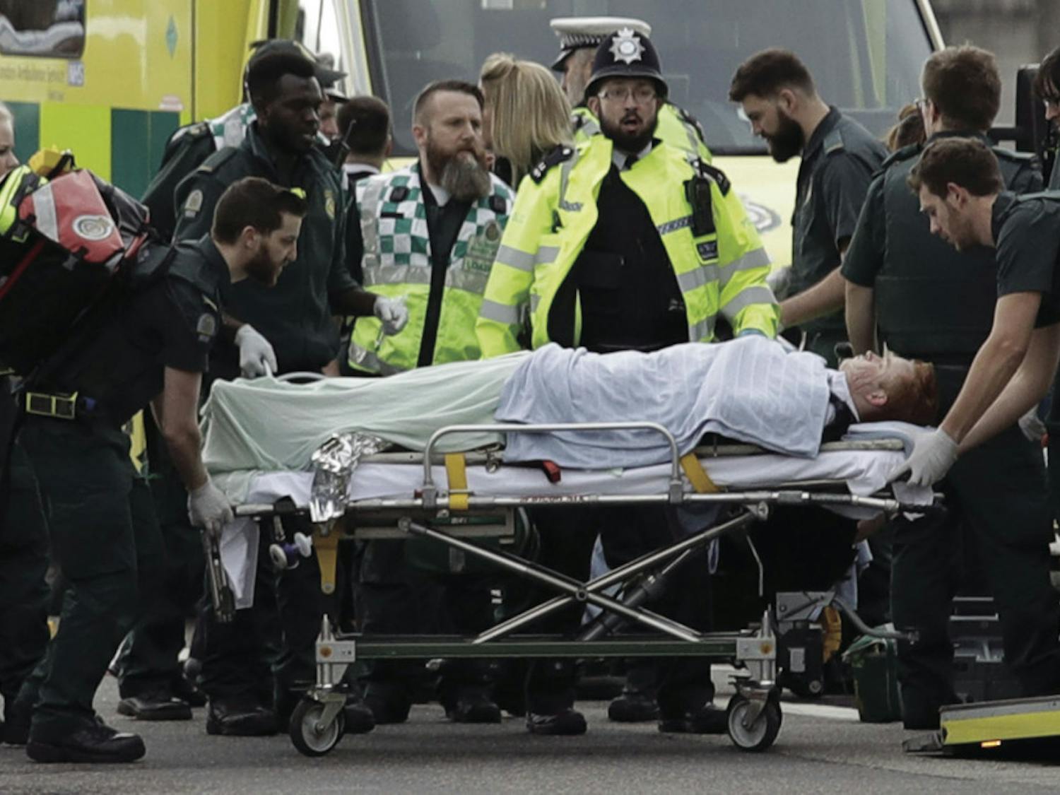 Emergency services staff provide medical attention to injured people on the south side of Westminster Bridge, close to the Houses of Parliament in London, Wednesday, March 22, 2017. London police say they are treating a gun and knife incident at Britain's Parliament "as a terrorist incident until we know otherwise." The Metropolitan Police says in a statement that the incident is ongoing. Officials say a man with a knife attacked a police officer at Parliament and was shot by officers. Nearby, witnesses say a vehicle struck several people on the Westminster Bridge.&nbsp;