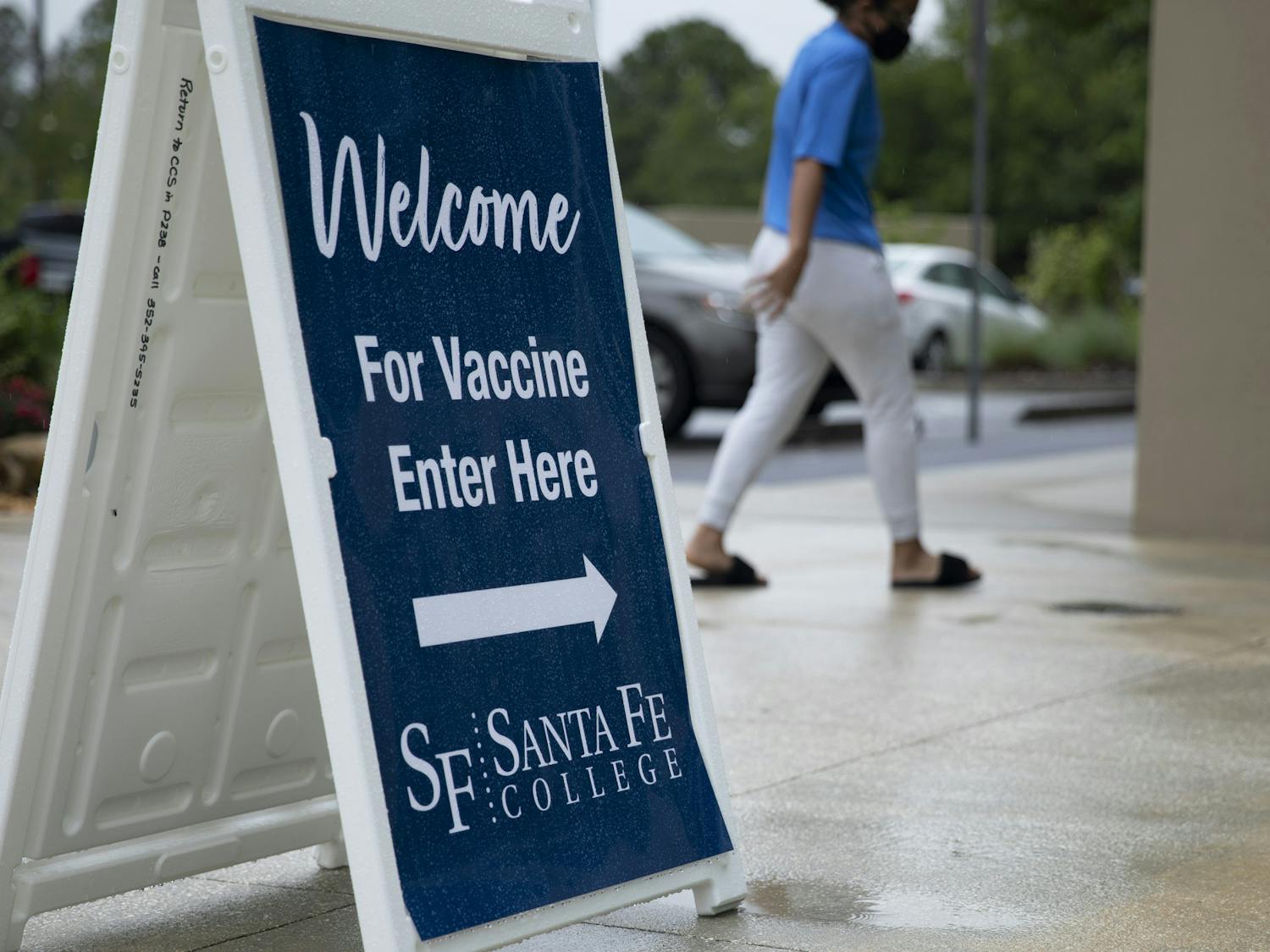A student walks into Santa Fe College Jackson N. Sasser Fine Arts Hall, where hosts a COVID vaccine event on Thursday morning 9 a.m., May 13, 2021, at the Jackson N. Sasser Fine Arts Hall on SF’s Northwest Campus for people to get their second vaccine.