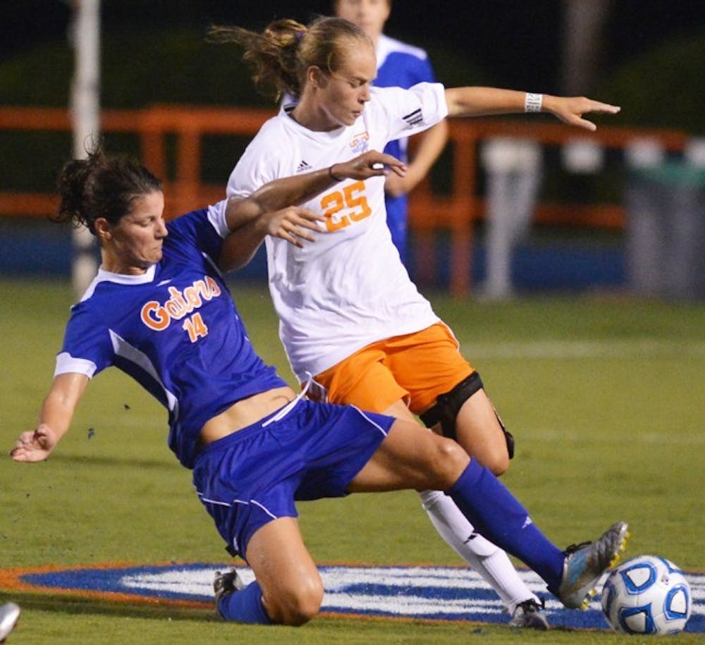 <p>Senior Jo Dragotta (14) steals the ball from Caroline Brown (25) of Tennessee on Friday at James G. Pressly Stadium. The Gators defeated the Volunteers 2-1.</p>