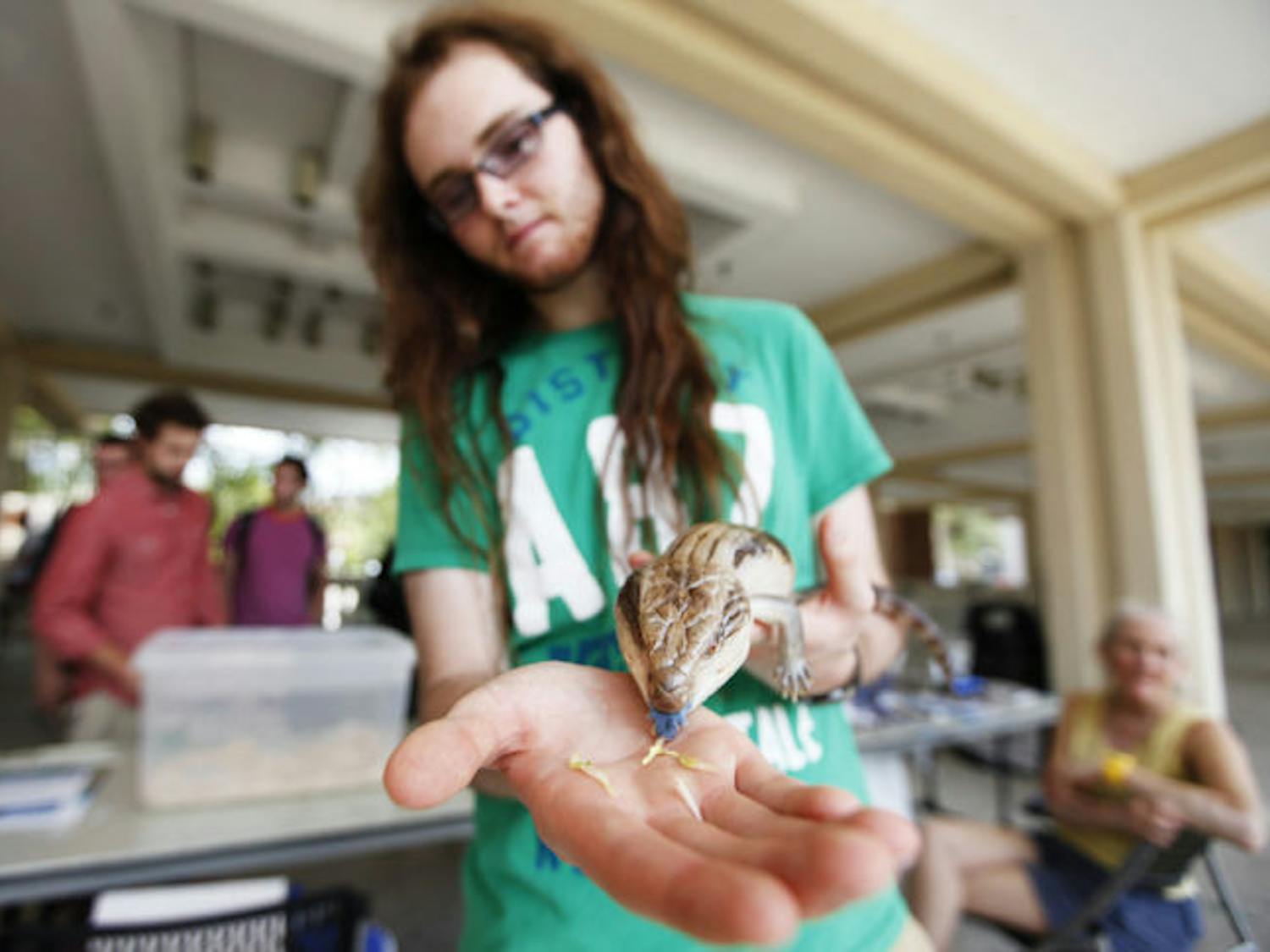 Sean McKnight, 19, a UF wildlife ecology and conservation freshman, holds his 16-year-old blue tongued skink, Jett, during the UF Exotic Pet Amnesty Day on the Reitz Union Colonnade on Tuesday.