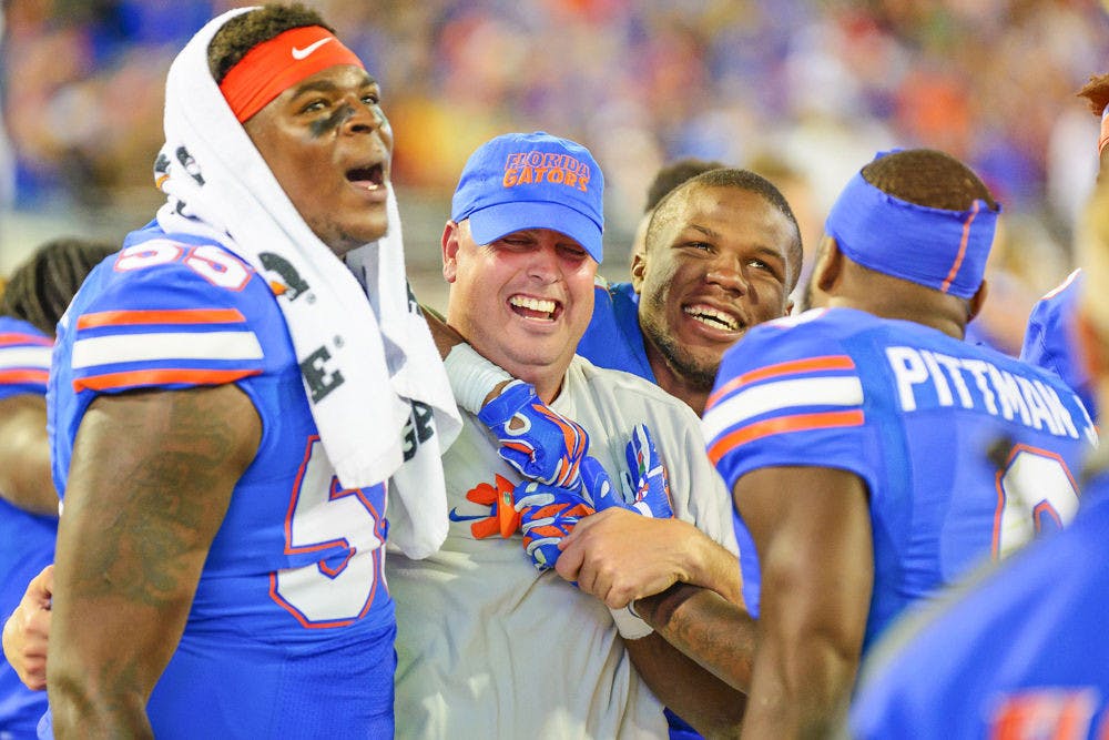 <p>Florida offensive coordinator Kurt Roper celebrates with players near the end of UF's 38-20 win against UGA on Nov. 1 at EverBank Field in Jacksonville.</p>