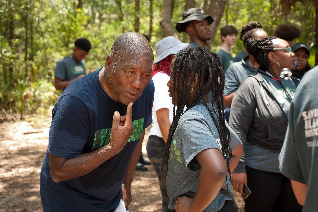 Marvin Dunn interacts with an attendee of a Teach The Truth tour through Rosewood, Fla., on June 25, 2023.