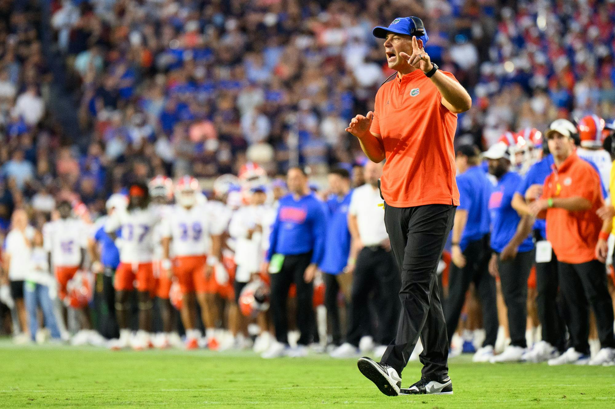 Florida head coach Jon Sumrall talks to a player during the first half of an NCAA college football game against Auburn, Saturday, Sept. 19, 2026, in Auburn, Ala.