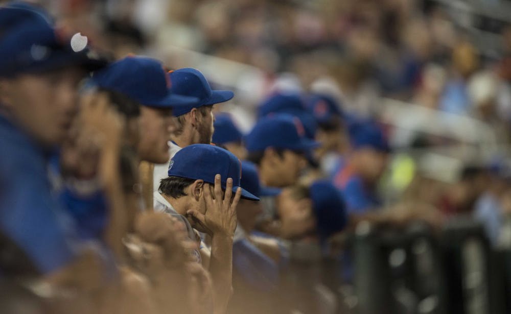 Florida players watch from the dugout during the Gators' 1-0 loss against Virginia in the NCAA Men's College World Series on Monday, June 15, 2015 at TD Ameritrade Park in Omaha.