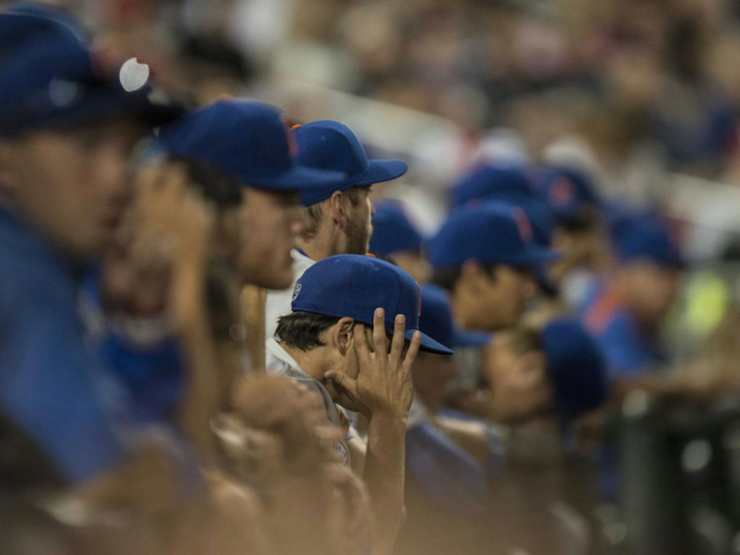 Florida players watch from the dugout during the Gators' 1-0 loss against Virginia in the NCAA Men's College World Series on Monday, June 15, 2015 at TD Ameritrade Park in Omaha.