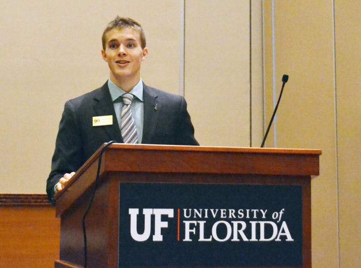 Senate President Dylan Fisher addresses a resolution supporting the Collegiate Housing and Infrastructure Act on Tuesday evening in the Reitz Union Grand Ballroom. All four resolutions passed.