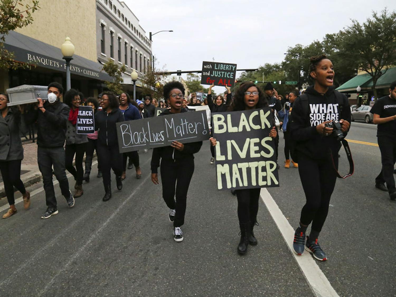 Protesters for the #BLACKLIVESMATTER march walk west on University Avenue on Monday afternoon.