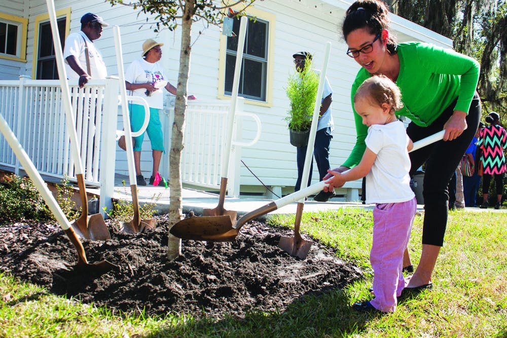 <p><span id="docs-internal-guid-3046aadc-ba12-28cc-8d43-487bd5f4885e"><span>Selena Patterson, a member of the City of Gainesville Beautification Board, helps her 2-year-old daughter, Scarlet, plant a tree for the City of Gainesville Arbor Day Celebration at the A. Quinn Jones House on Thursday. The Arbor Day celebration had live music, a light lunch and a free tree giveaway.</span></span></p>
