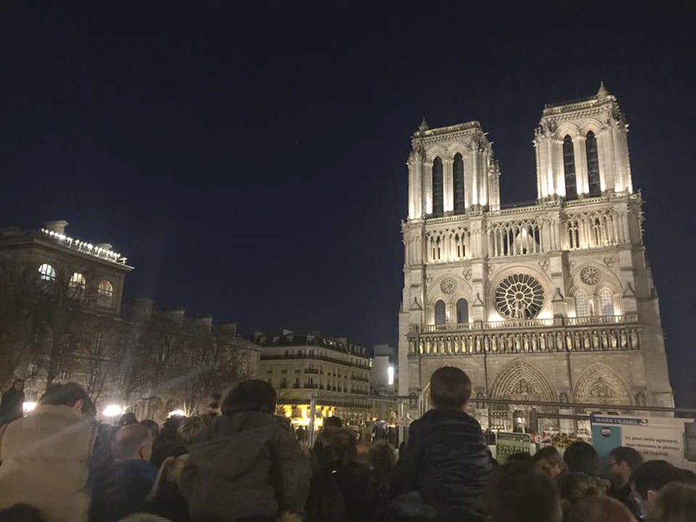 Thousands of people attended a memorial service at Notre Dame Cathedral in Paris on Nov. 15, 2015. Children sat on their parents' shoulders and old ladies stood outside the church, watching the service live-streamed on their phones. "It was a very impactful moment," said Pedro Perez, a 20-year-old UF history and political science junior studying abroad in France, who took the photo.