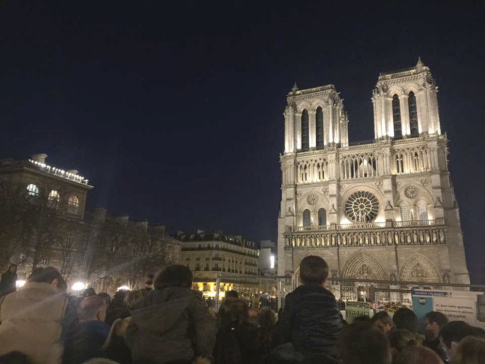 <p>Thousands of people attended a memorial service at Notre Dame Cathedral in Paris on Nov. 15, 2015. Children sat on their parents' shoulders and old ladies stood outside the church, watching the service live-streamed on their phones. "It was a very impactful moment," said Pedro Perez, a 20-year-old UF history and political science junior studying abroad in France, who took the photo.</p>