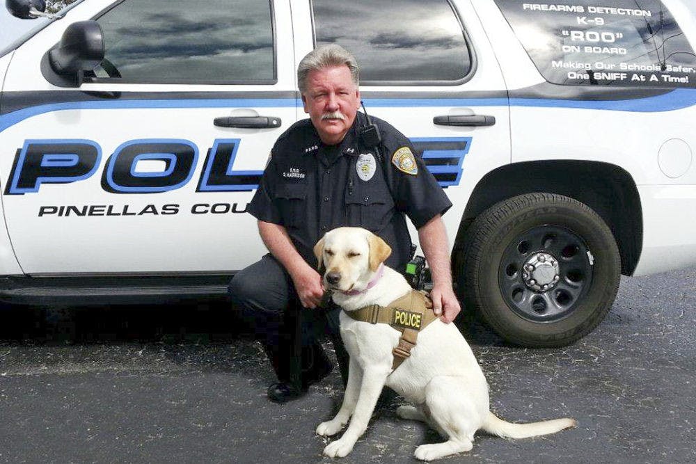 <p>Officer David Harrison, of Pinellas County, poses for a picture with Roo the K9 dog.</p>