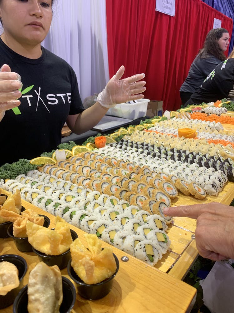 Taste of Greater Gainesville attendees samples sushi provided by Taste, a local restaurant that serves Pan-Asian cuisine.