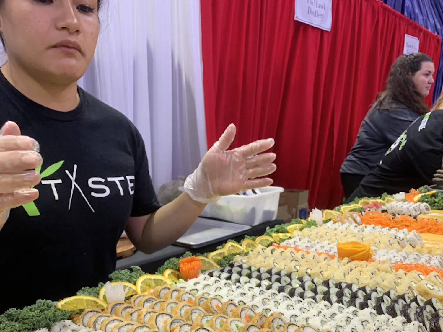 Taste of Greater Gainesville attendees samples sushi provided by Taste, a local restaurant that serves Pan-Asian cuisine.