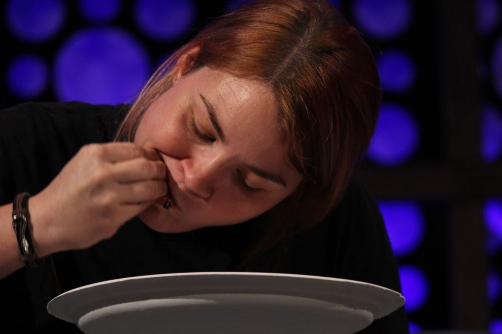 Andrea Reddick, 32, eats a mullet’s eye during an eating contest at the 10 CAN Banquet &amp; Wild Florida Feast on Saturday.
