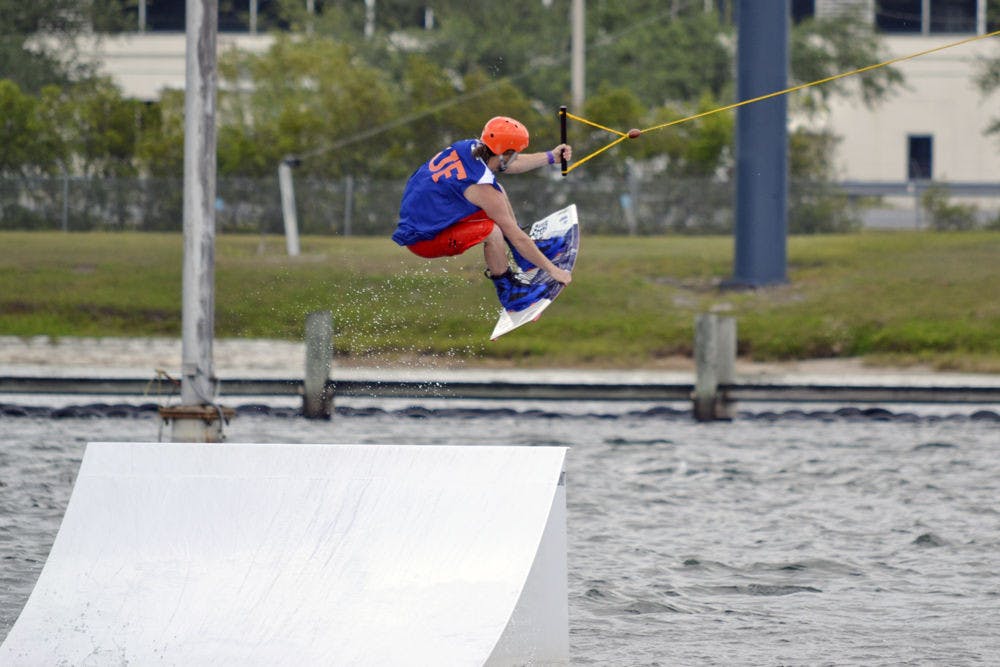 Michael Hanna, a 22-year-old UF biochemistry senior, performs a wakeboard stunt on cables in the Orlando Watersports Complex on Sunday afternoon. UF’s Wakeboarding Club placed second in the Red Bull Rival competition over the weekend.
