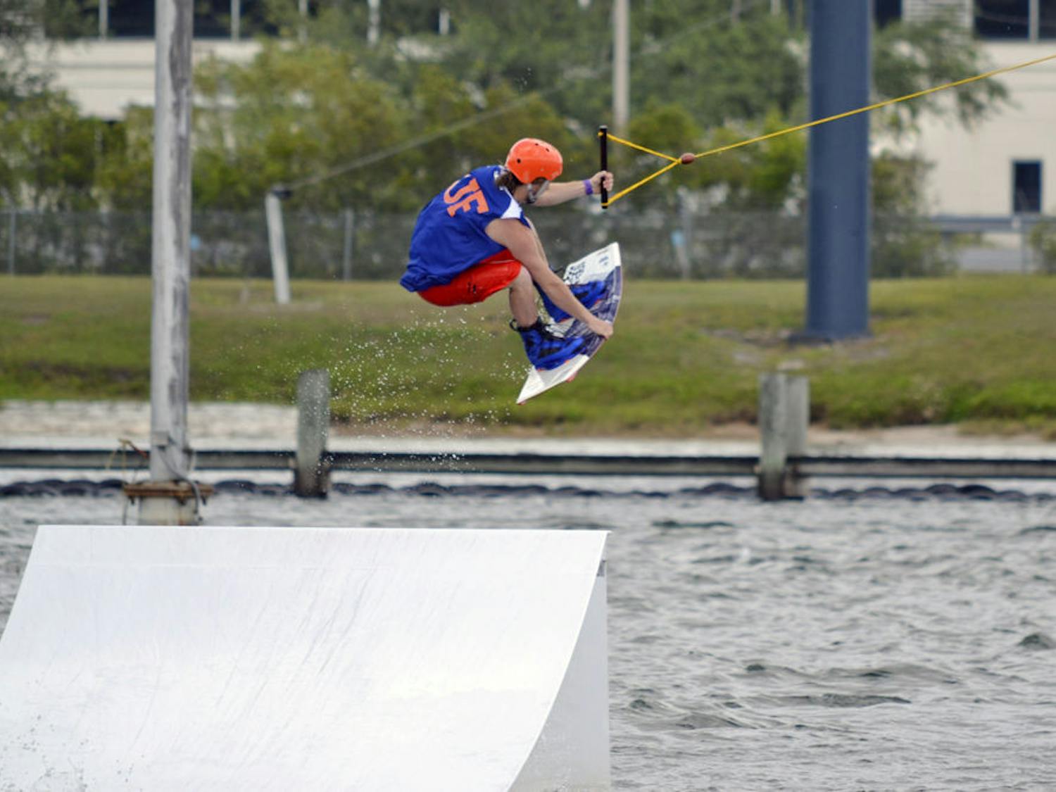 Michael Hanna, a 22-year-old UF biochemistry senior, performs a wakeboard stunt on cables in the Orlando Watersports Complex on Sunday afternoon. UF’s Wakeboarding Club placed second in the Red Bull Rival competition over the weekend.