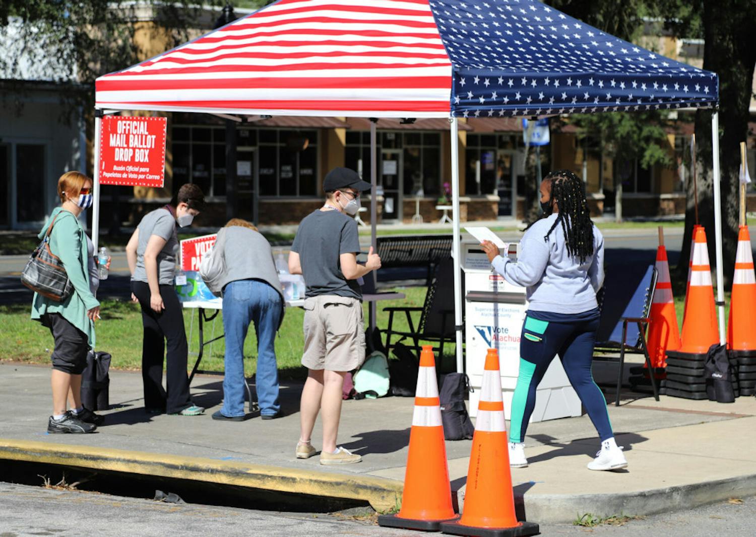 Voters are seen dropping off their mail ballots at the Supervisor of Elections Office in Gainesville, Fla., on Tuesday, Nov. 3, 2020.