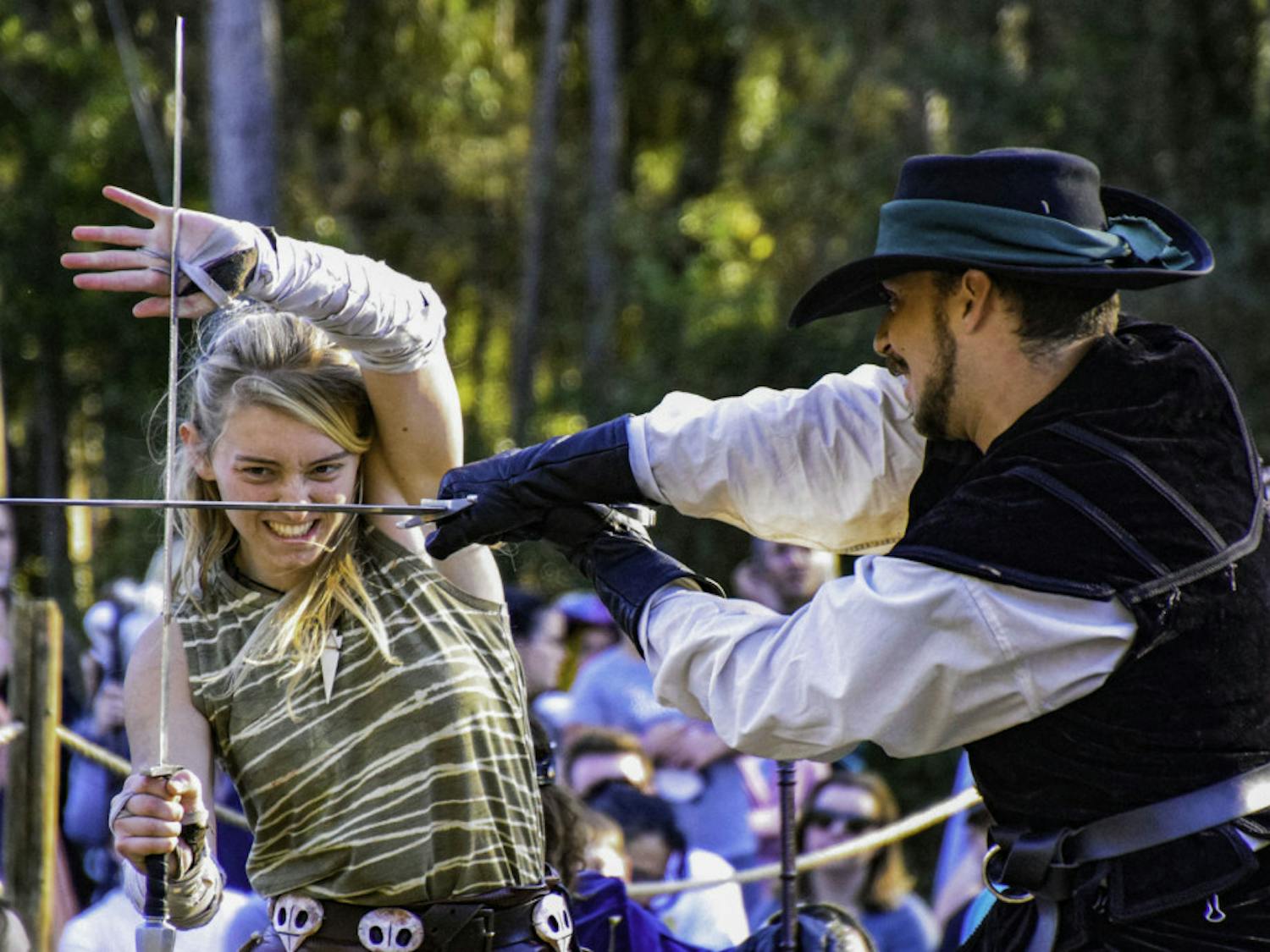 Thieves Guilde actors Sierra Barnier, 18, and Kevin Otero, 24, perform a choreographed sword fight during a chess game.