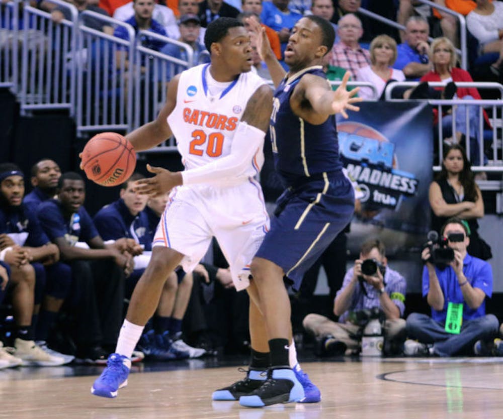 <p>Michael Frazier II drives the ball during Florida’s 61-45 win against Pittsburgh during the 2014 NCAA Tournament.&nbsp;</p>