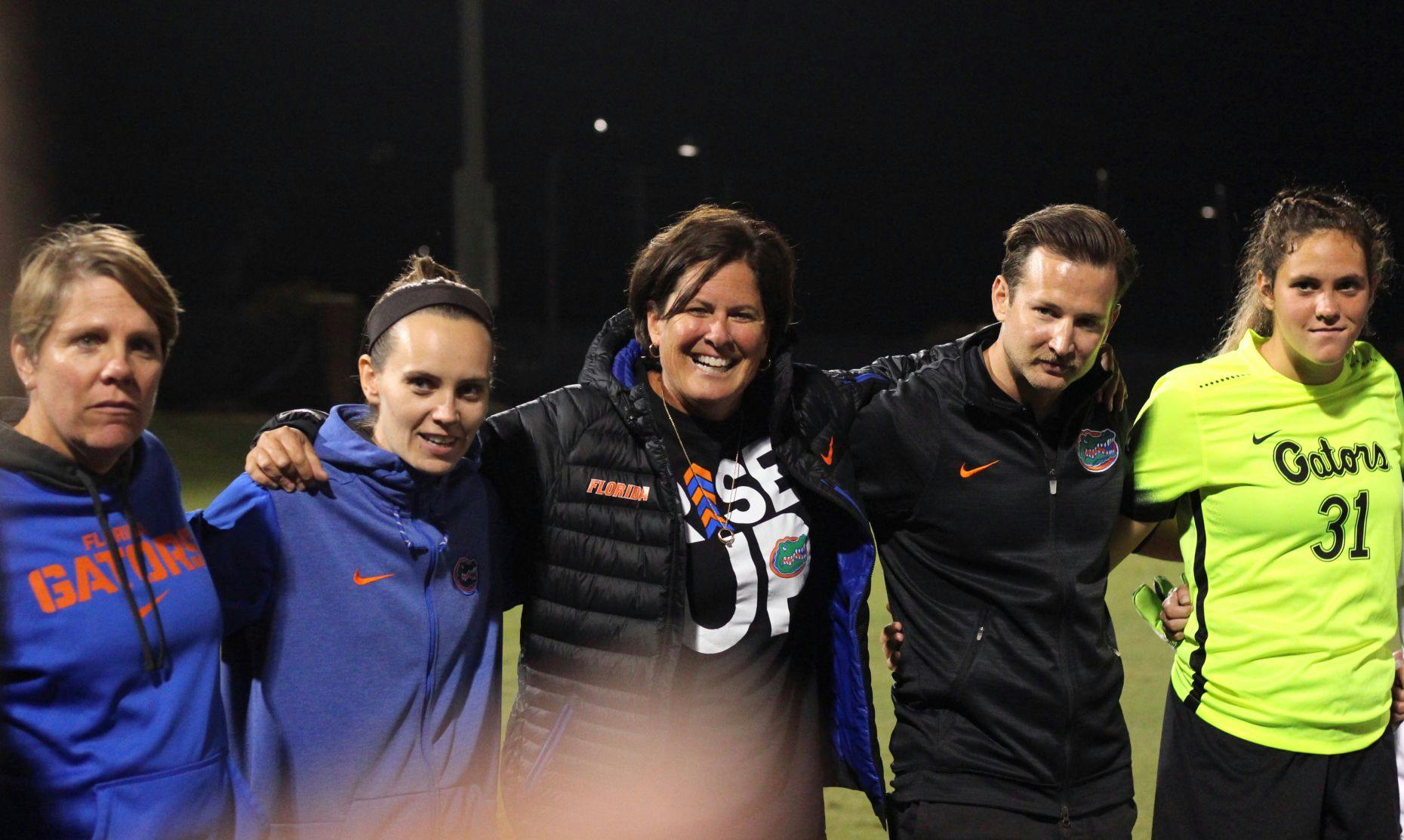 Coach Becky Burleigh (center) celebrates with her team following its victory over USF in the 2017 NCAA Tournament.&nbsp;