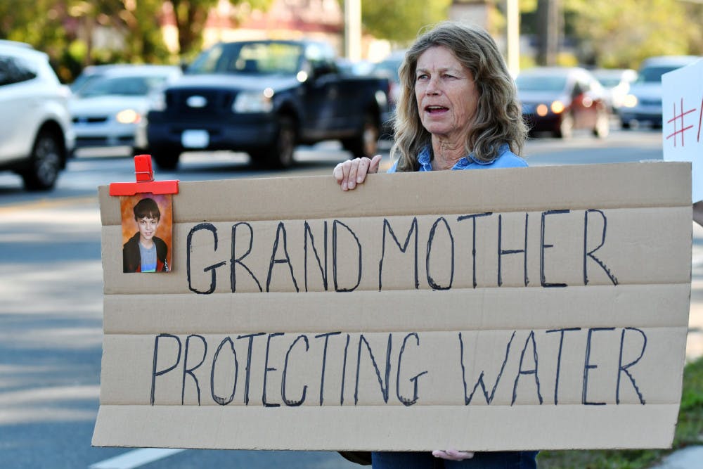 Sharon Huston holds a sign with her grandson James’ picture on the corner of Northwest 43rd Street and Northwest 23rd Avenue. Huston said she is worried the pipeline’s proximity to Dunnellon schools could affect her grandson and the community. 