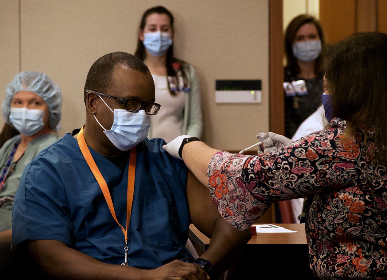 Dr. Joseph Tyndall receives the second Pfizer-BioNTech COVID-19 vaccine administered at UF Health Shands Cancer Hospital on Dec. 16, 2020. (photo by Julia Coin)