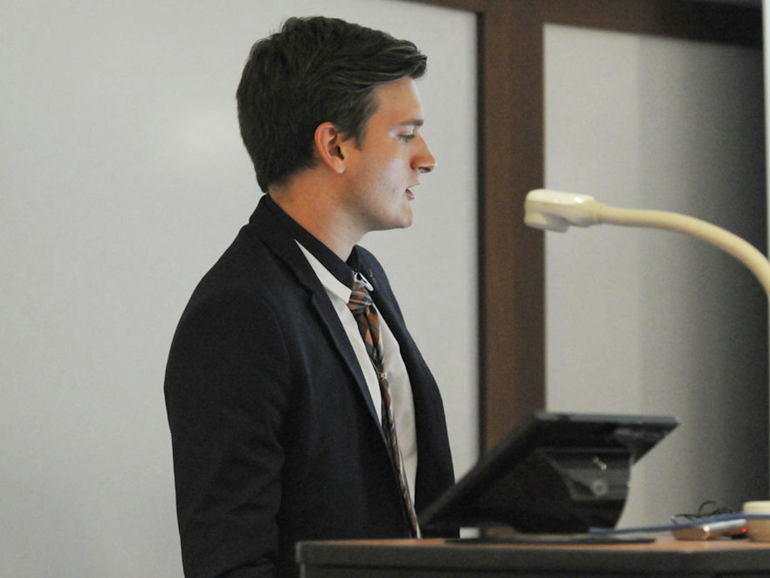 Ty Robare, comprehensive statute reform ad hoc committee chairman, gives his committee report at Tuesday's Student Senate meeting prior to the second reading of the reforms.