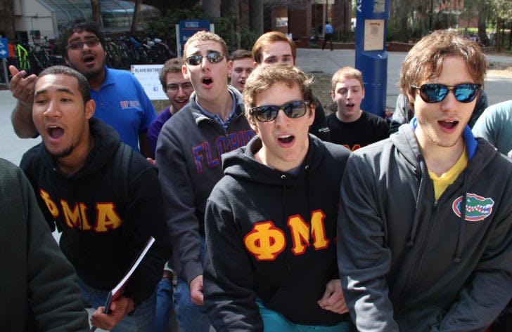 Brothers of Phi Mu Alpha serenade students walking near the front of the Reitz Union on Thursday. The music fraternity is selling Valentine’s Day serenades to anyone in Gainesville as a fundraiser for Relay for Life and other organizations. For more information, visit&nbsp;ufphimualpha.com.