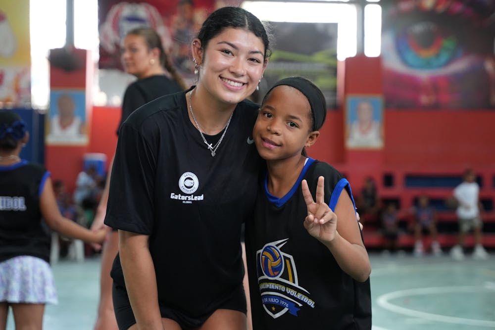 <p><strong>UF Women’s Gymnastics athlete Kayla DiCello poses with a Gators Experience 2025 participant in the Dominican Republic.  </strong></p>