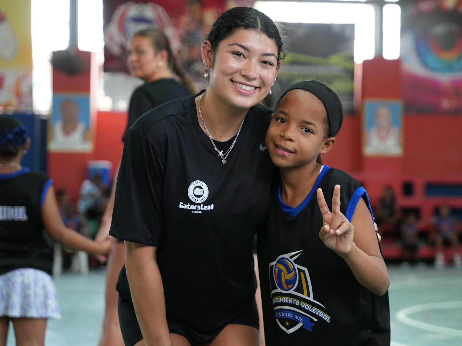 UF Women’s Gymnastics athlete Kayla DiCello poses with a Gators Experience 2025 participant in the Dominican Republic.