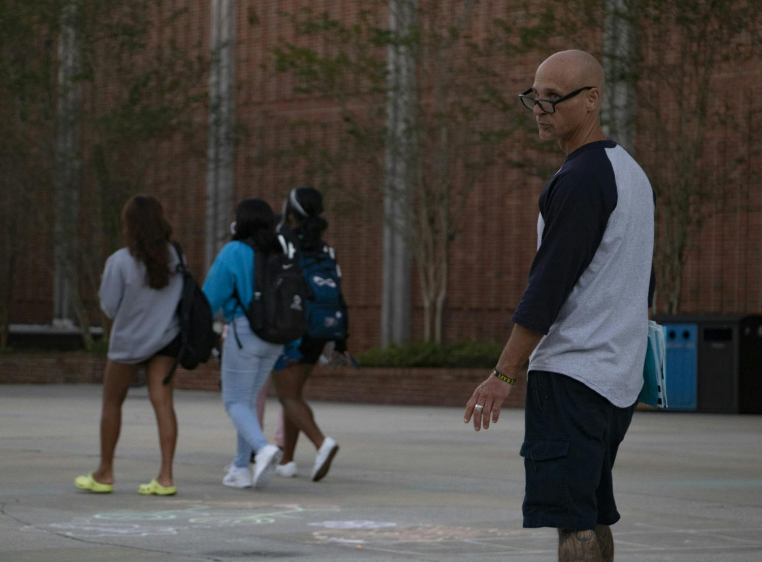 A petitioner looks for people to sign the blue petition outside the Reitz Union on Thursday, Oct. 28, 2021. "This is a good cause," he said. "The Seminoles are getting jerked around by the government." He warned that the green petition is not a good one.