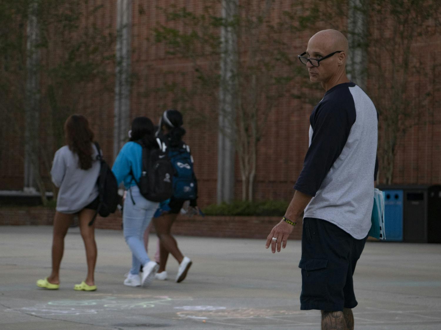 A petitioner looks for people to sign the blue petition outside the Reitz Union on Thursday, Oct. 28, 2021. "This is a good cause," he said. "The Seminoles are getting jerked around by the government." He warned that the green petition is not a good one.